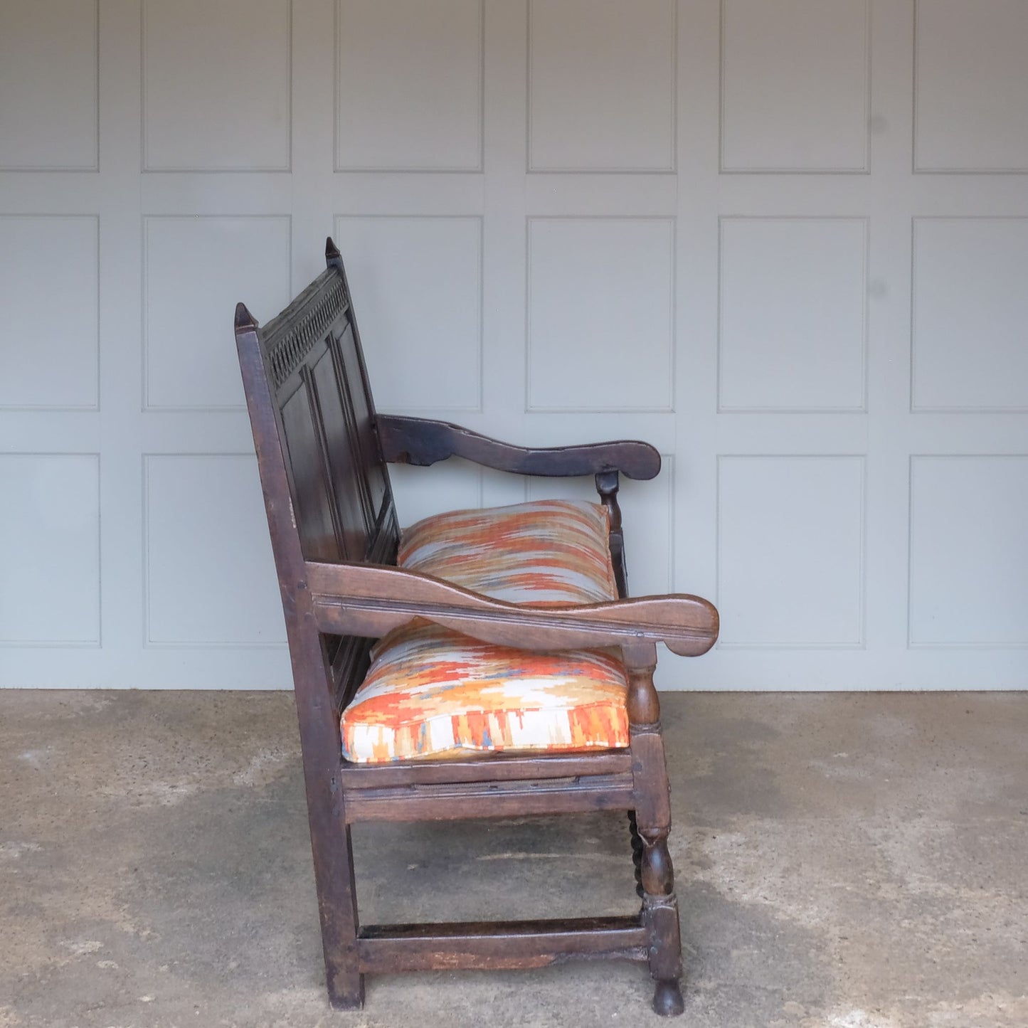 A side view of Vintage 18th Century Oak Settle with Upholstered Cushion - Summerfield & Scott