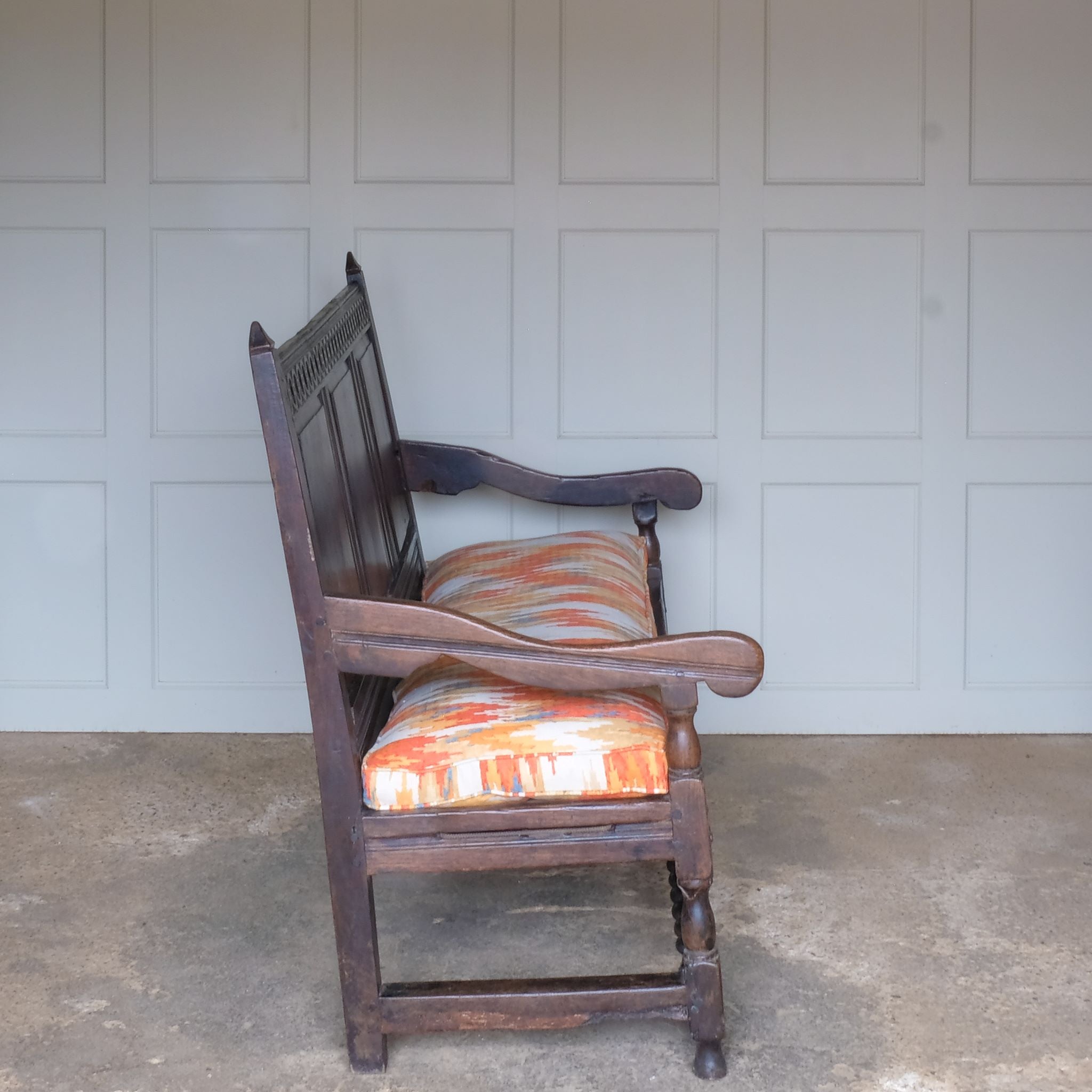 A side view of Vintage 18th Century Oak Settle with Upholstered Cushion - Summerfield & Scott