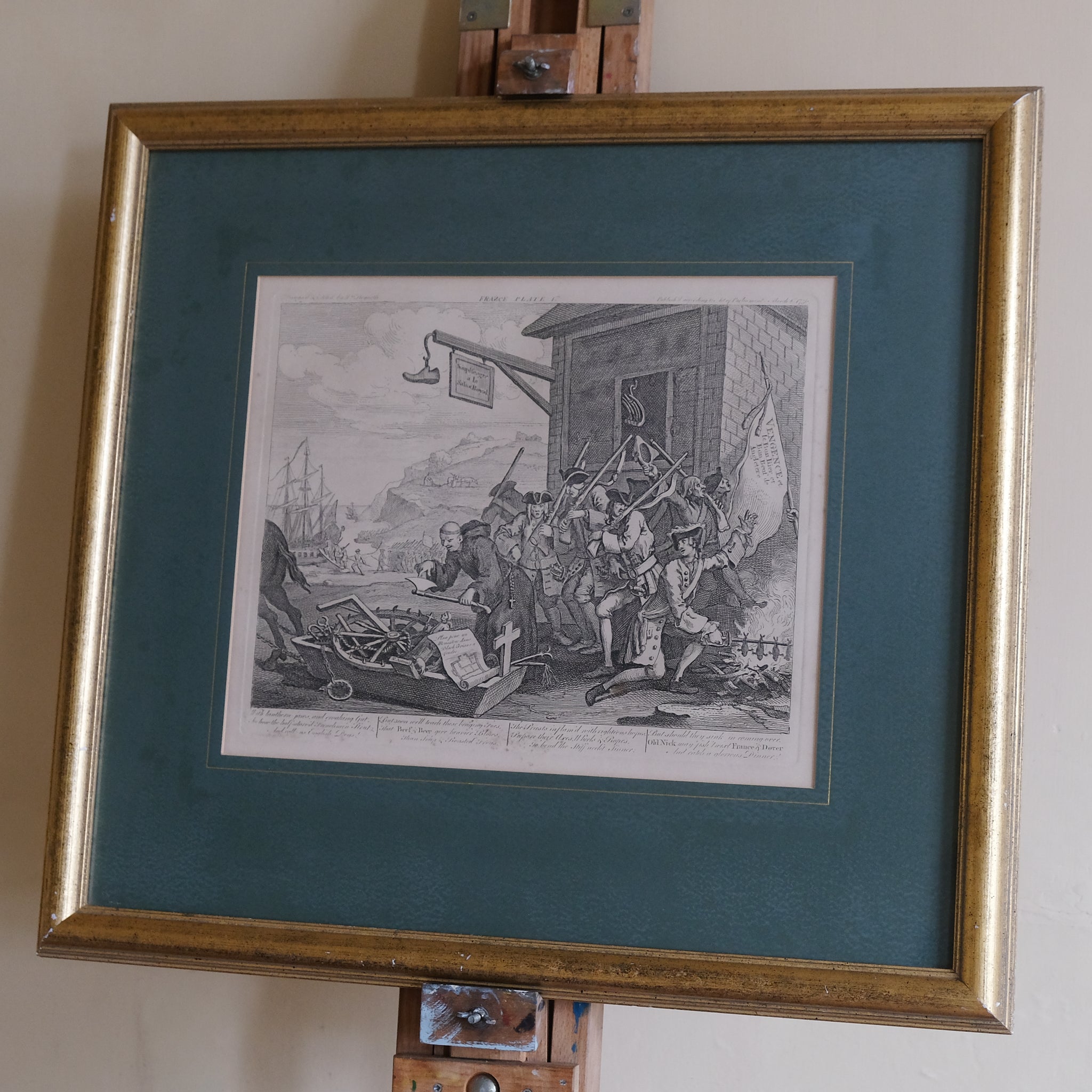 Framed black and white print on a stand with a teal mat