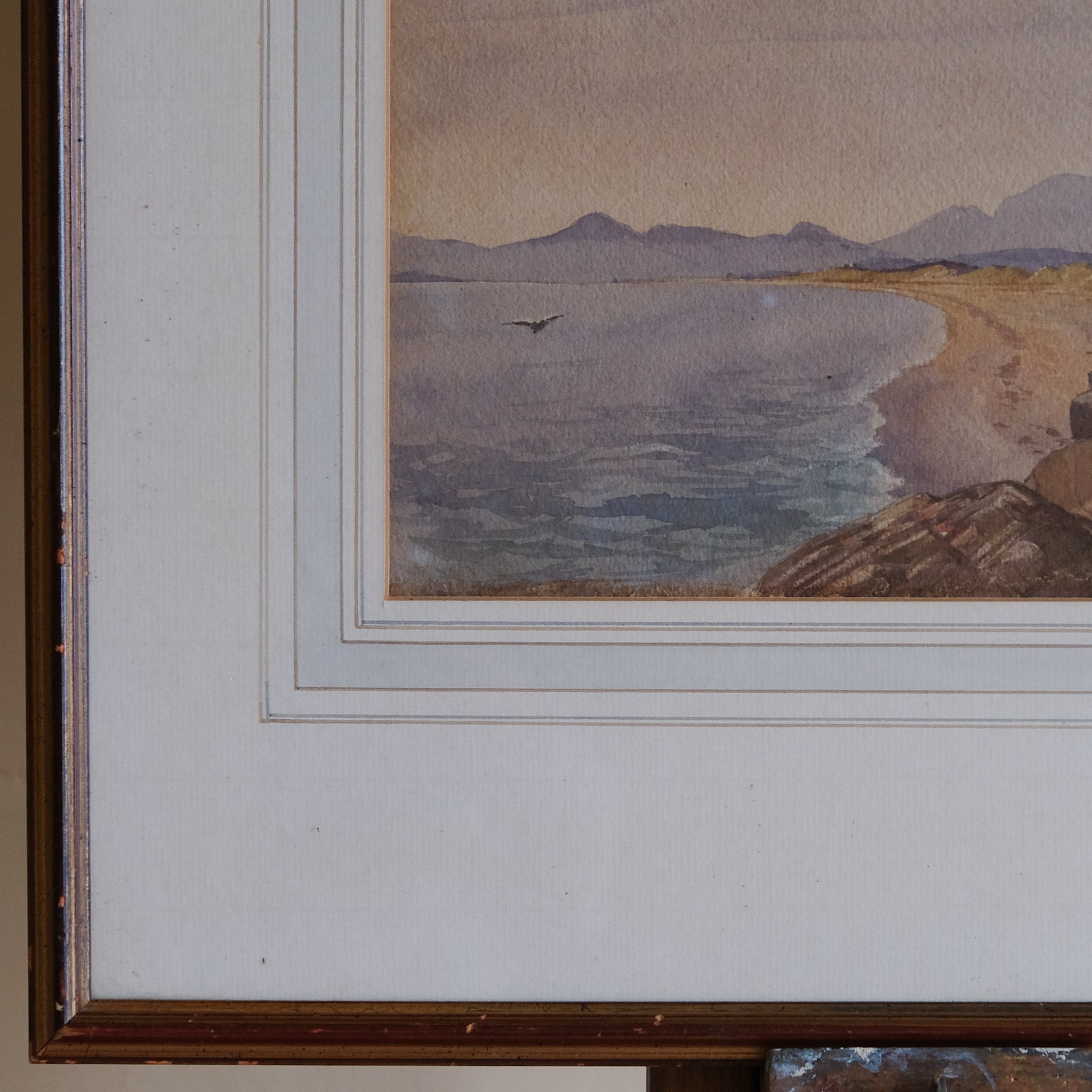 COASTAL LANDSCAPE WITH MOUNTAINS IN THE DISTANCE