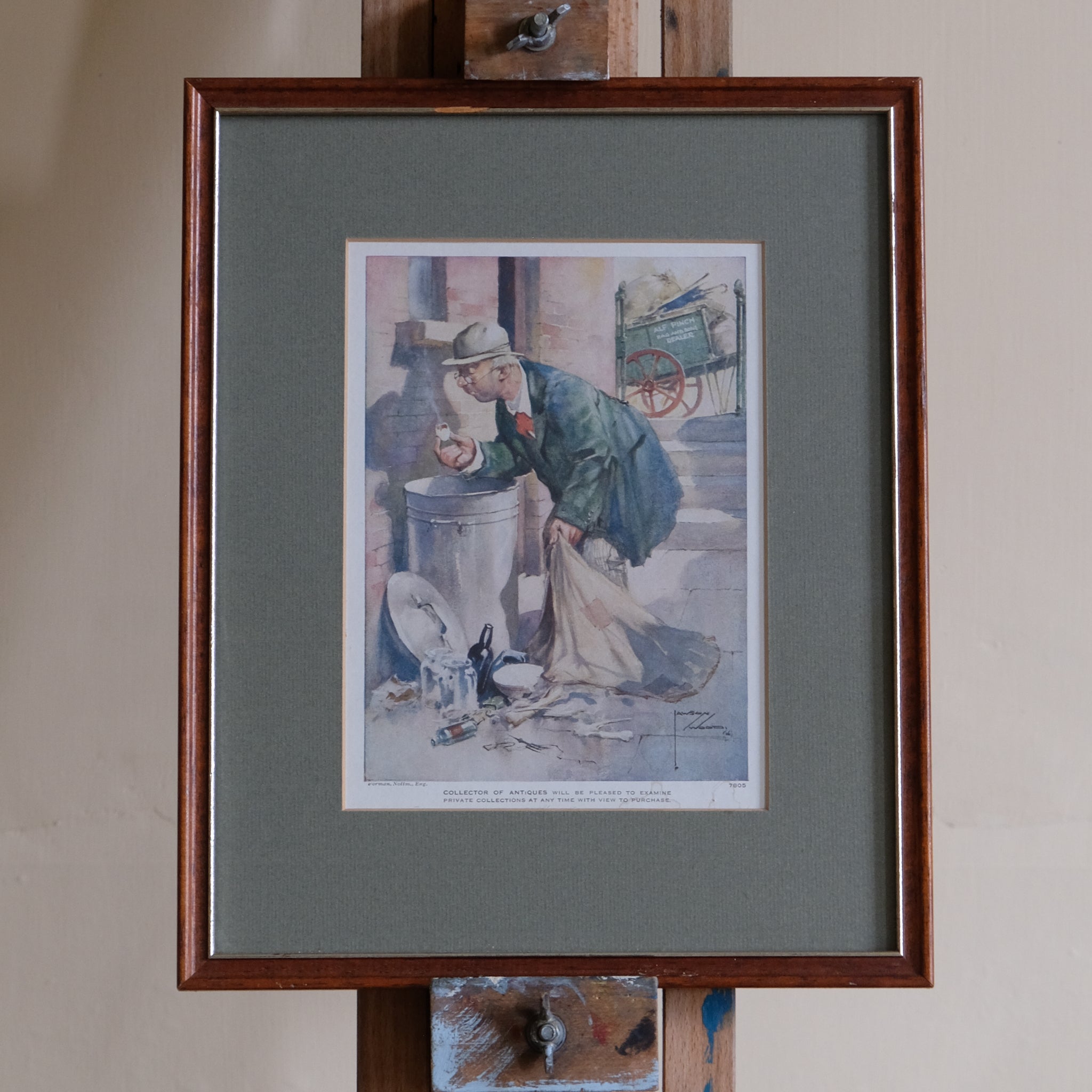 Framed artwork of a man with a dog on a street scene