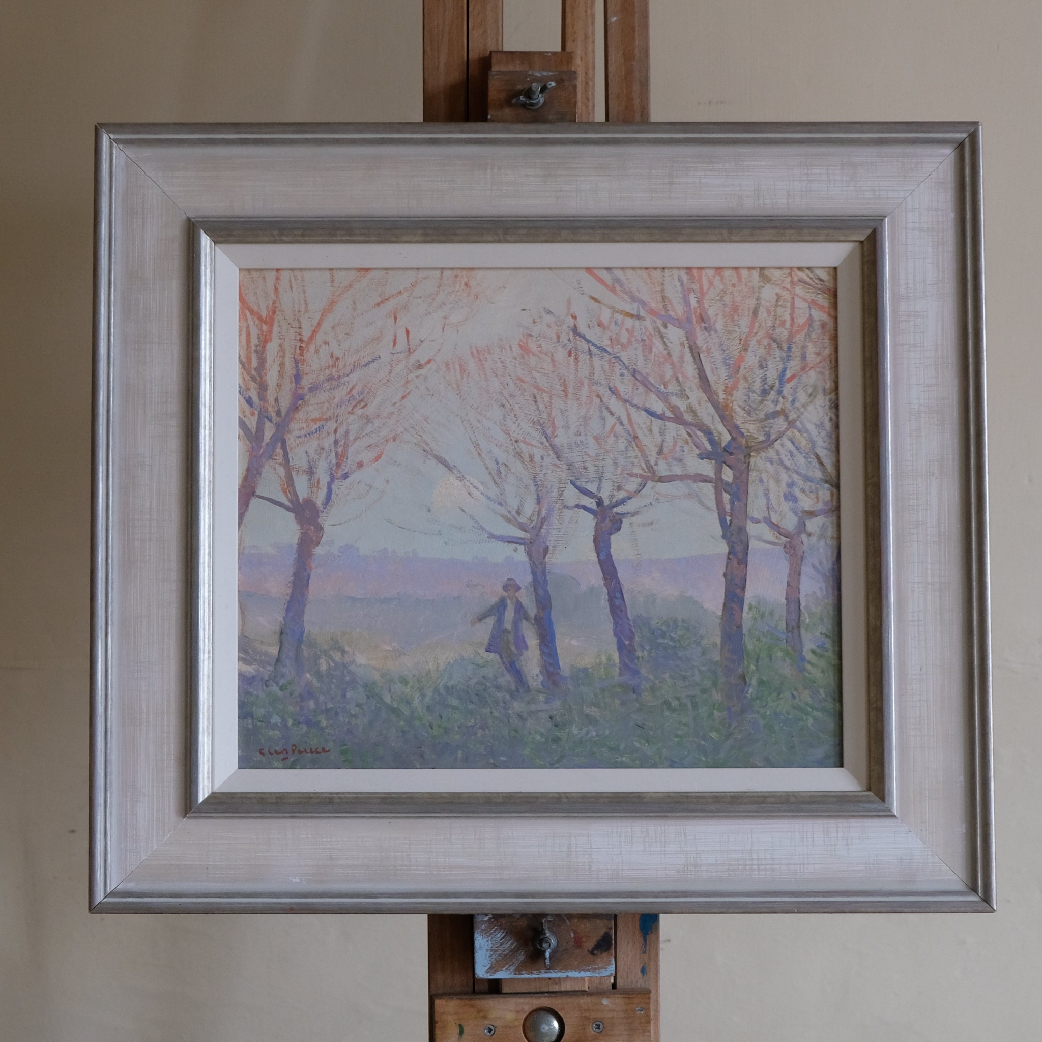 Framed painting, Glen Preece, of a landscape with trees and a person on an easel.