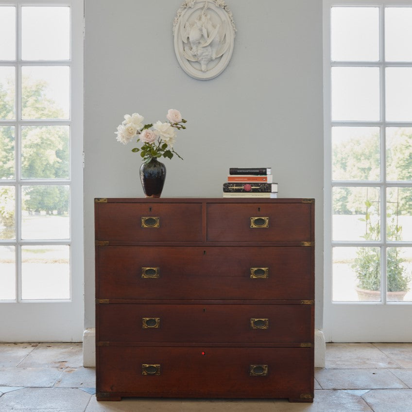 A beautiful brass bound mahogany campaign chest, early 19th century, comprised of two sections with two short over three long drawers with recessed brass handles on the drawers and sides, with a gentle patina commensurate with its age and use, the drawers in excellent working condition. Splits into two for easy manoeuvre. It would make a distinctive and attractive addition to a bedroom or hallway.