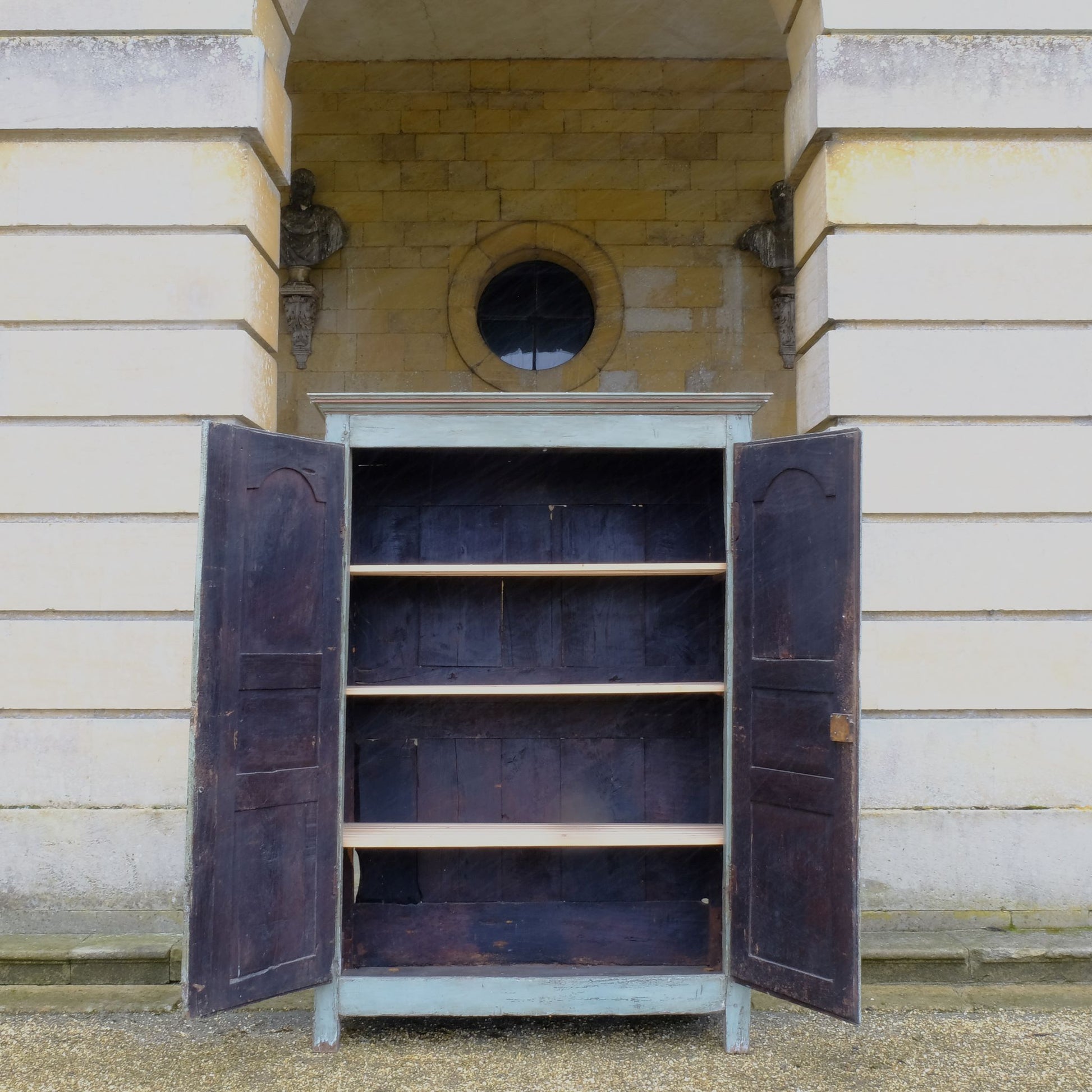 A large 19th century French light blue/green painted cupboard. A moulded cornice above panelled doors with decorative iron hinges and single escutcheon with key. A beautiful colour combination, with a charming crackled patina throughout. Fitted with new slatted shelving to the interior, would make great use as pantry or housekeeper's cupboard.