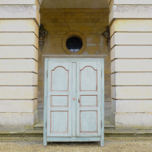 A large 19th century French light blue/green painted cupboard. A moulded cornice above panelled doors with decorative iron hinges and single escutcheon with key. A beautiful colour combination, with a charming crackled patina throughout. Fitted with new slatted shelving to the interior, would make great use as pantry or housekeeper's cupboard.