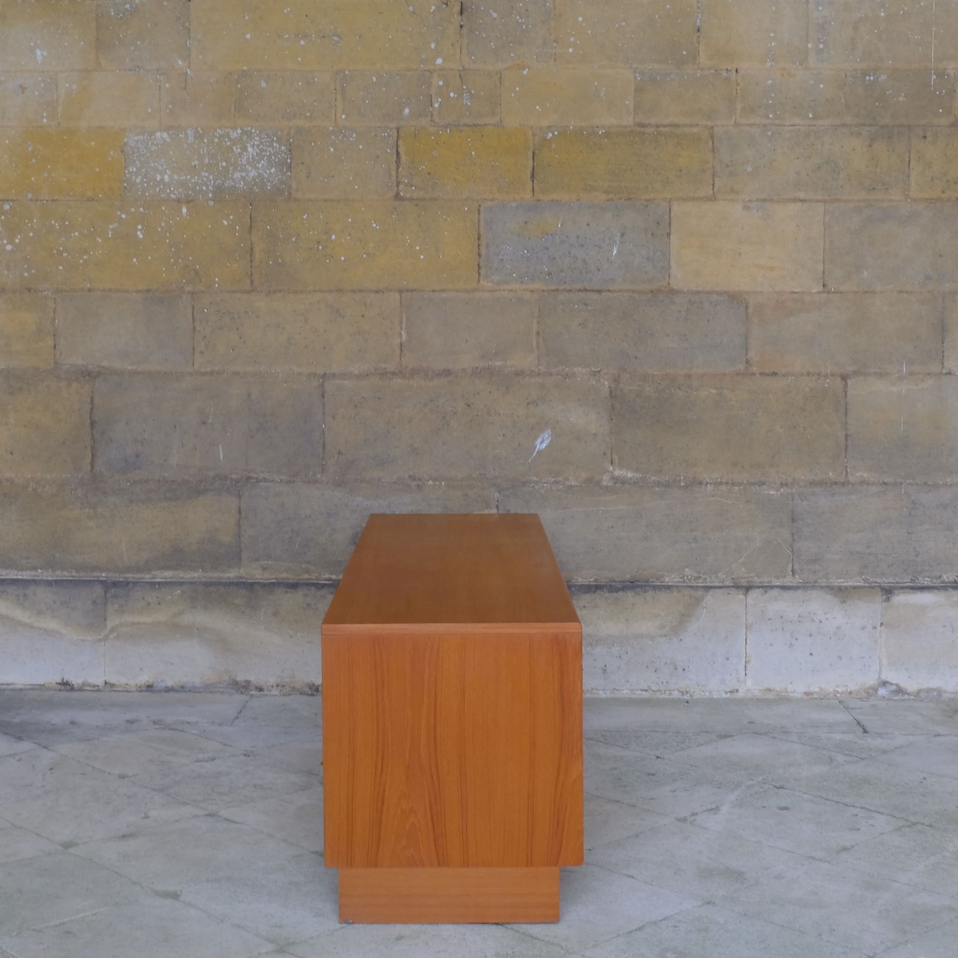 A low teak mid century sideboard by G Plan. Two spacious cabinets, each with a pair of doors and single internal shelf. The maker's mark is present inside one of the doors. In lovely condition, with some very light marks to the top, commensurate with the item's age.