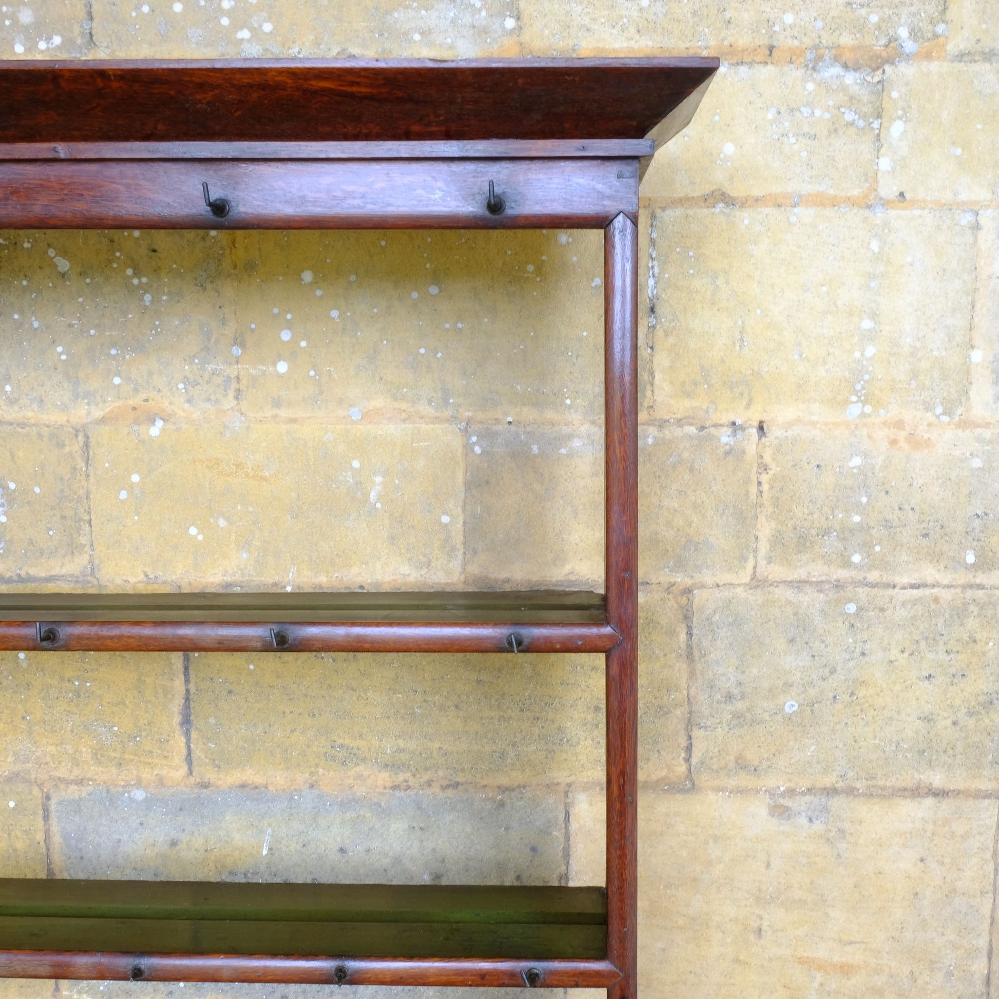 An 18th century dresser in a beautiful rich oak, with open plate shelves over a two drawer base with a twin arched apron on turned legs with a boarded lower shelf. Various hooks along the three shelves and top. Comes in two pieces for easy transport and maneuver. A delightful patina commensurate with age throughout, with some faint signs of an old green tint to the top of the shelves. In very good solid structural condition.