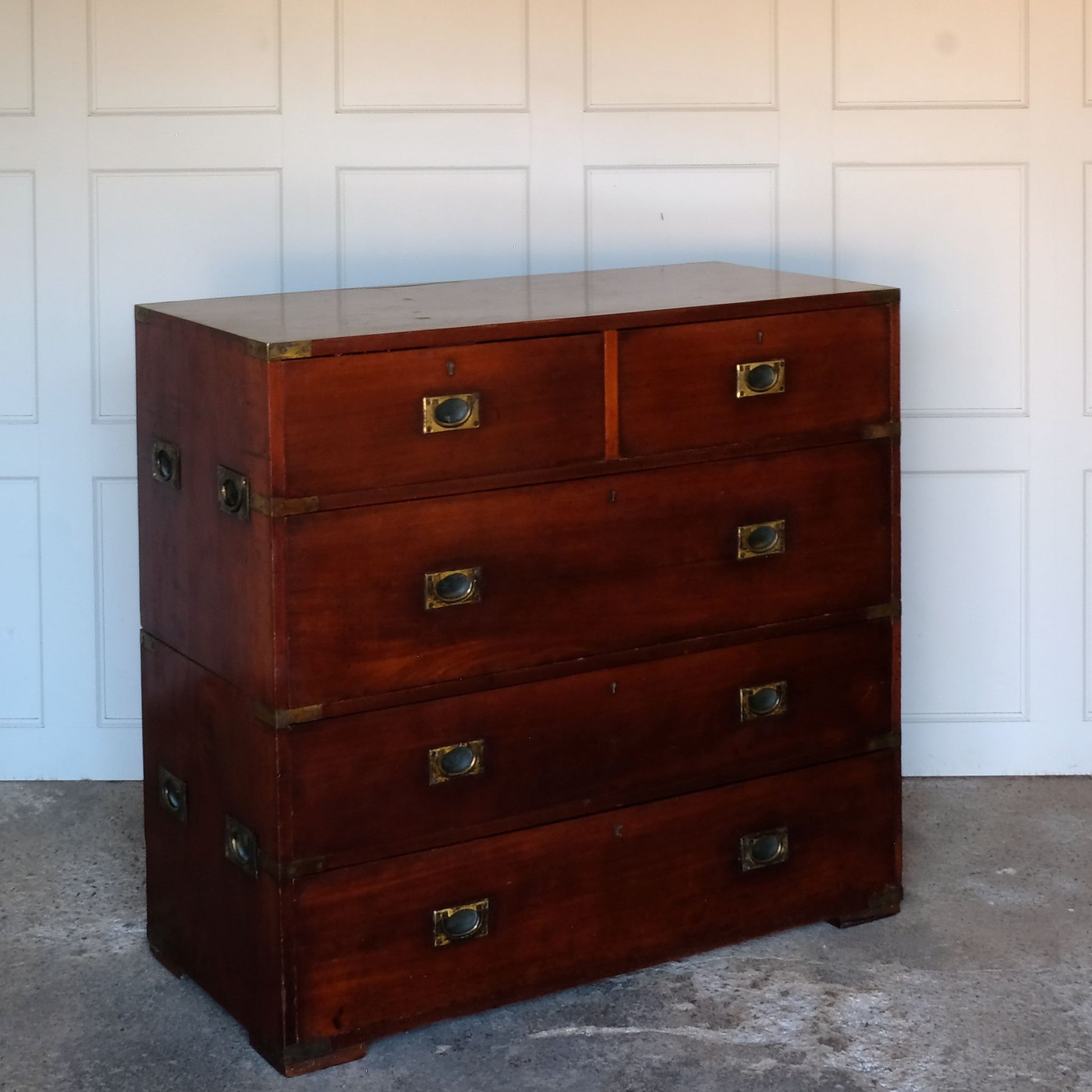 A beautiful brass bound mahogany campaign chest, early 19th century, comprised of two sections with two short over three long drawers with recessed brass handles on the drawers and sides, with a gentle patina commensurate with its age and use, the drawers in excellent working condition. Splits into two for easy manoeuvre. It would make a distinctive and attractive addition to a bedroom or hallway.