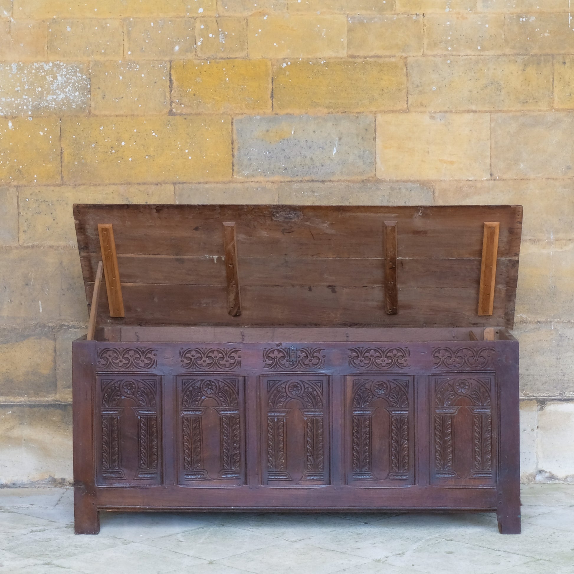 A large 17th century oak coffer with a beautiful five panelled front - lid open
