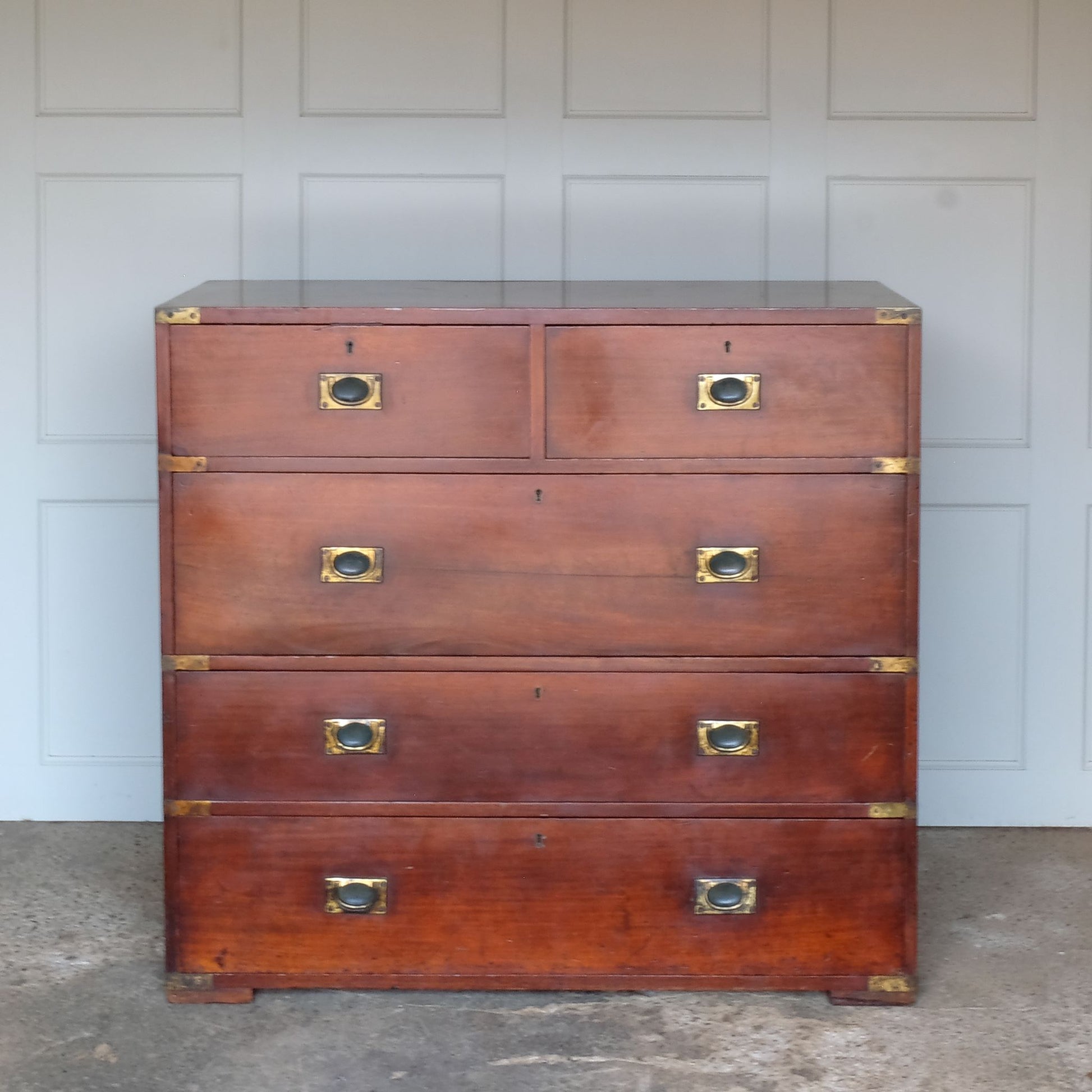 A beautiful brass bound mahogany campaign chest, early 19th century, comprised of two sections with two short over three long drawers with recessed brass handles on the drawers and sides, with a gentle patina commensurate with its age and use, the drawers in excellent working condition. Splits into two for easy manoeuvre. It would make a distinctive and attractive addition to a bedroom or hallway.