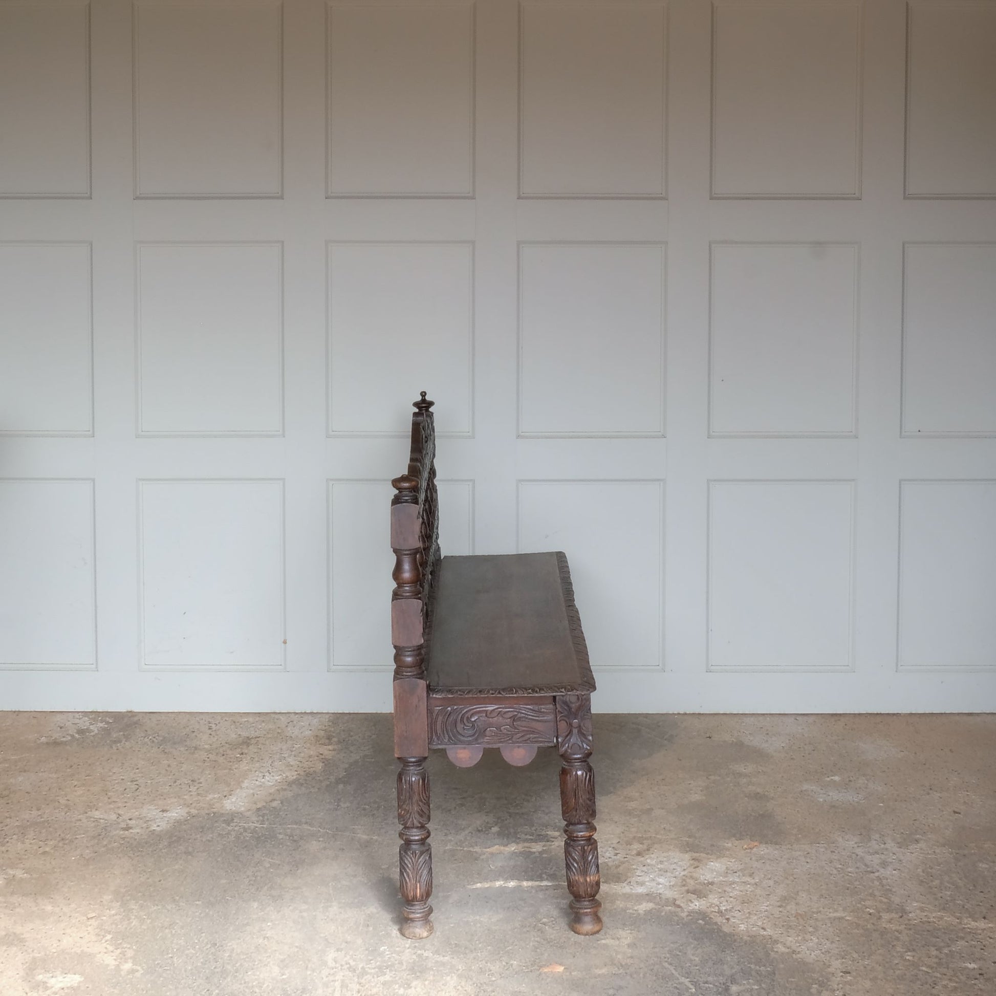 A small oak carved bench, perfect for children, late 19th / early 20th century. With a beautiful foliate carved design. A repaired split to the back rest, in sturdy condition but showing signs of a long and well loved life.