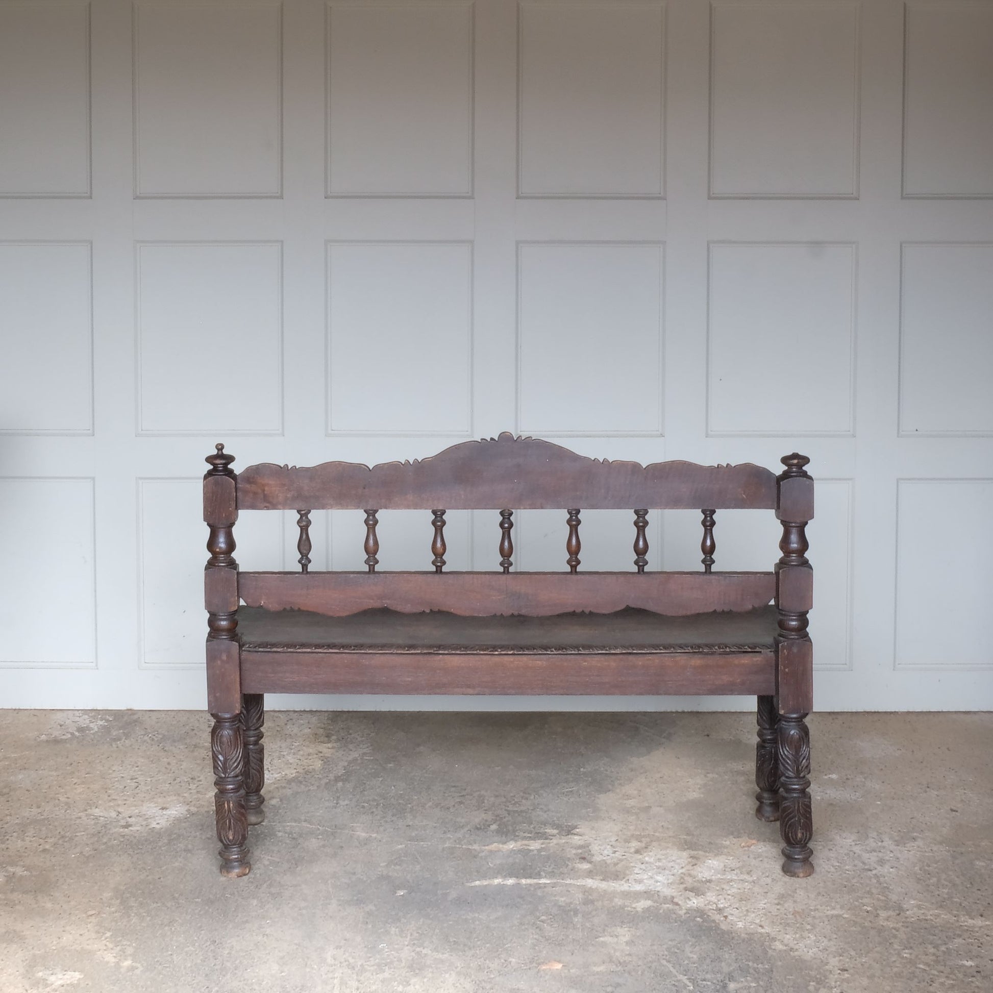 A small oak carved bench, perfect for children, late 19th / early 20th century. With a beautiful foliate carved design. A repaired split to the back rest, in sturdy condition but showing signs of a long and well loved life.