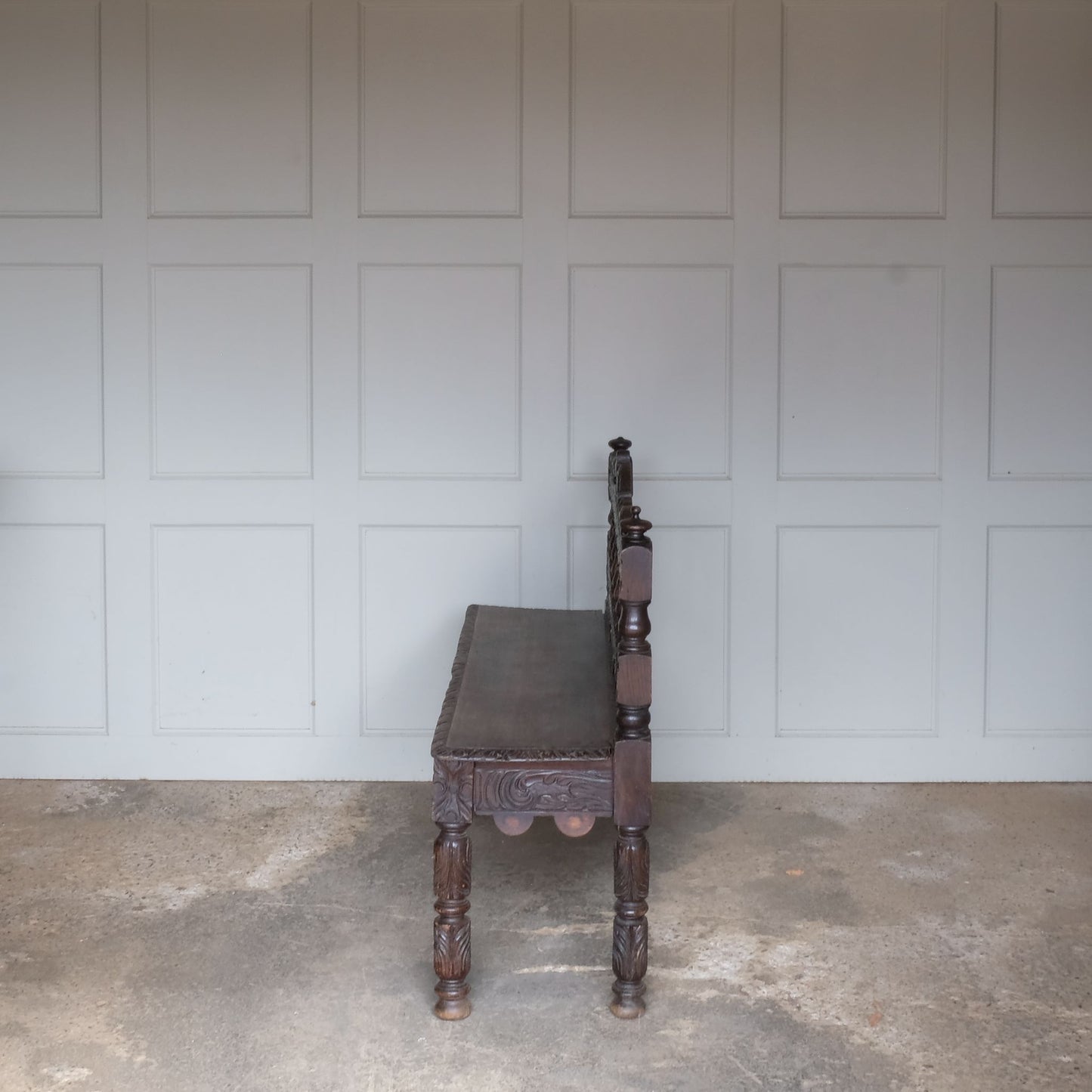 A small oak carved bench, perfect for children, late 19th / early 20th century. With a beautiful foliate carved design. A repaired split to the back rest, in sturdy condition but showing signs of a long and well loved life.