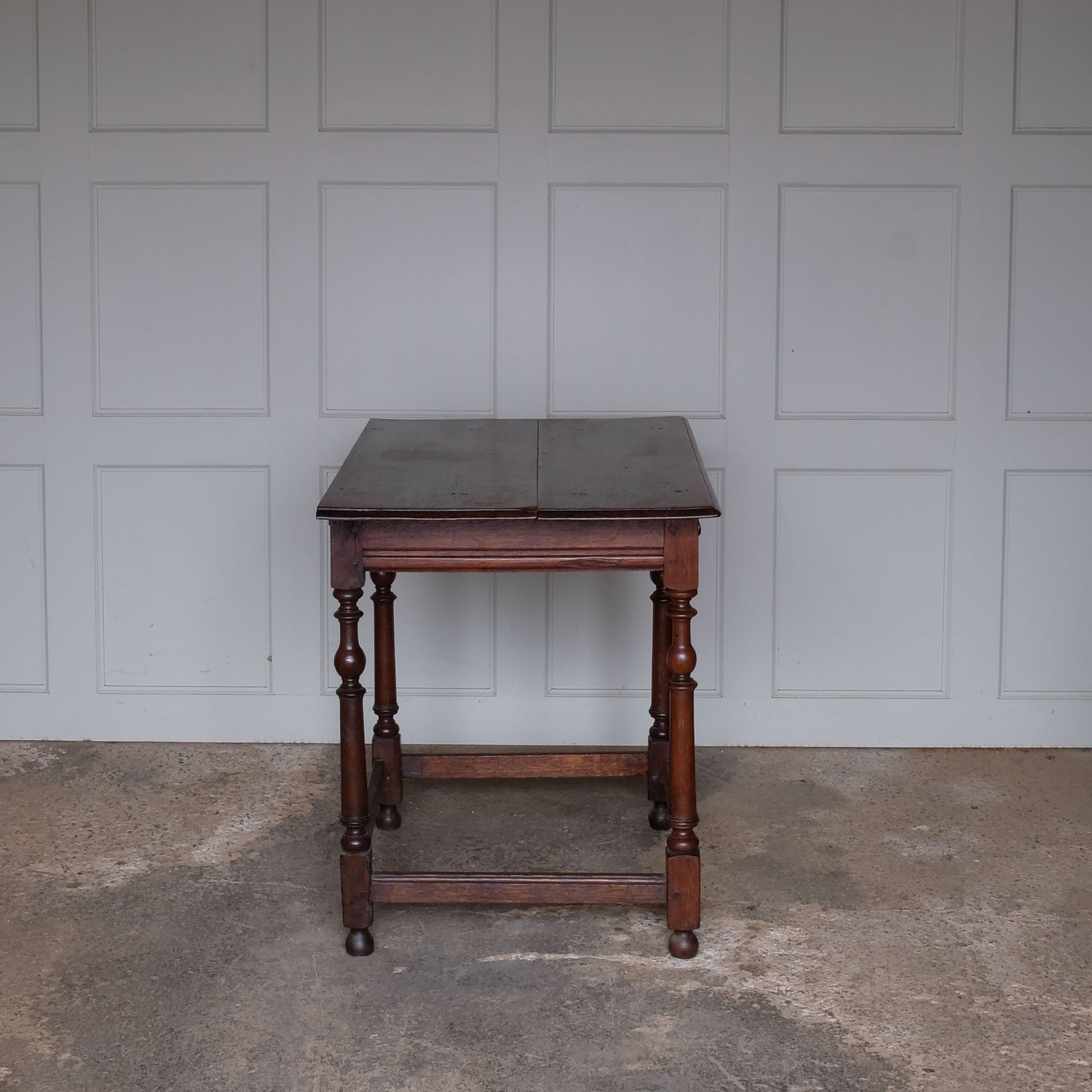 A fine 17th century English oak side table with a lovely well-patinated two plank moulded top with with flying overhangs above a single drawer over tapered and ring-turned legs joined by box stretchers. A very useful size for use in either a living room, small hallway or as an elegant bedside table.
