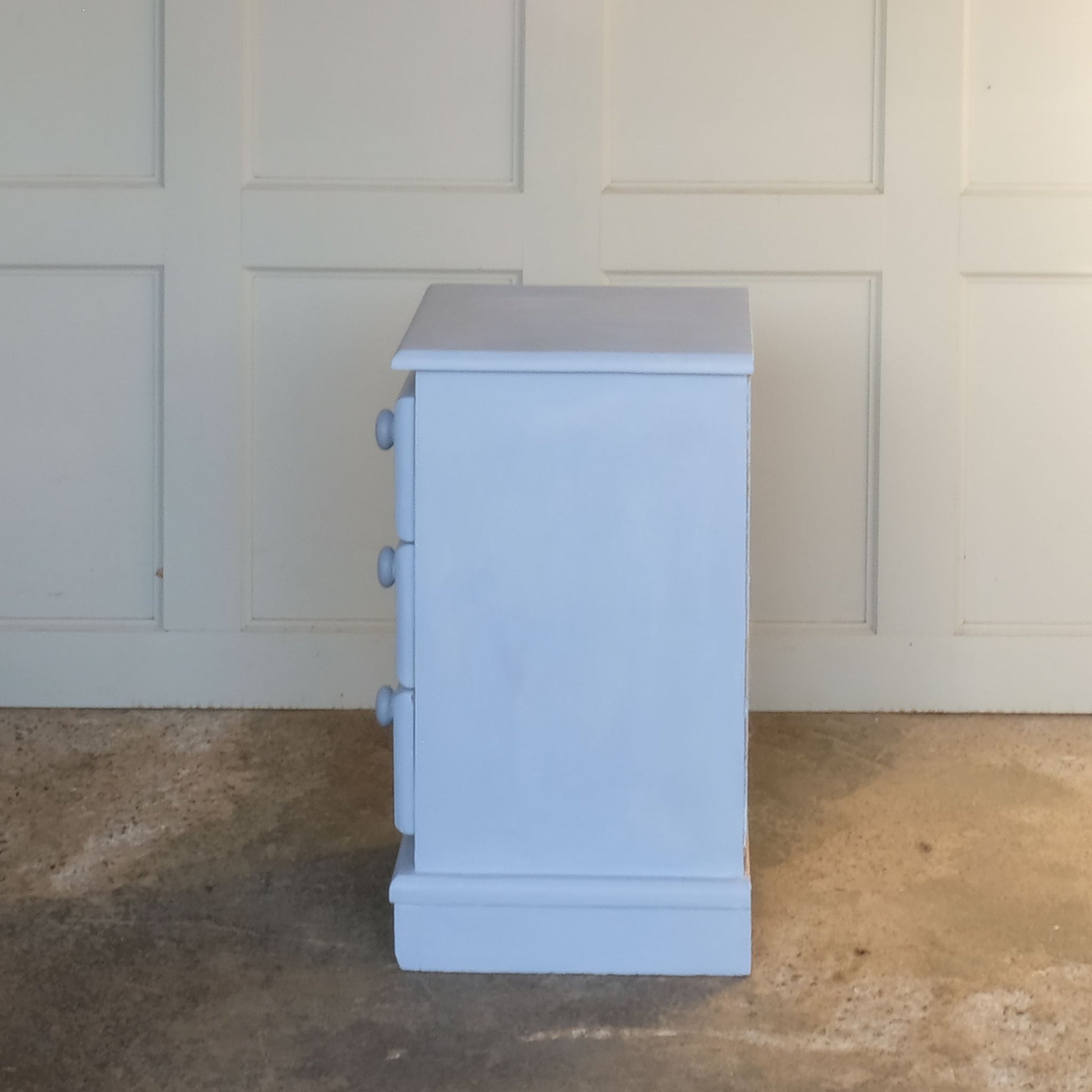 Side view of Small hand painted blue vintage chest of drawers or bedside table by Summerfield & Scott