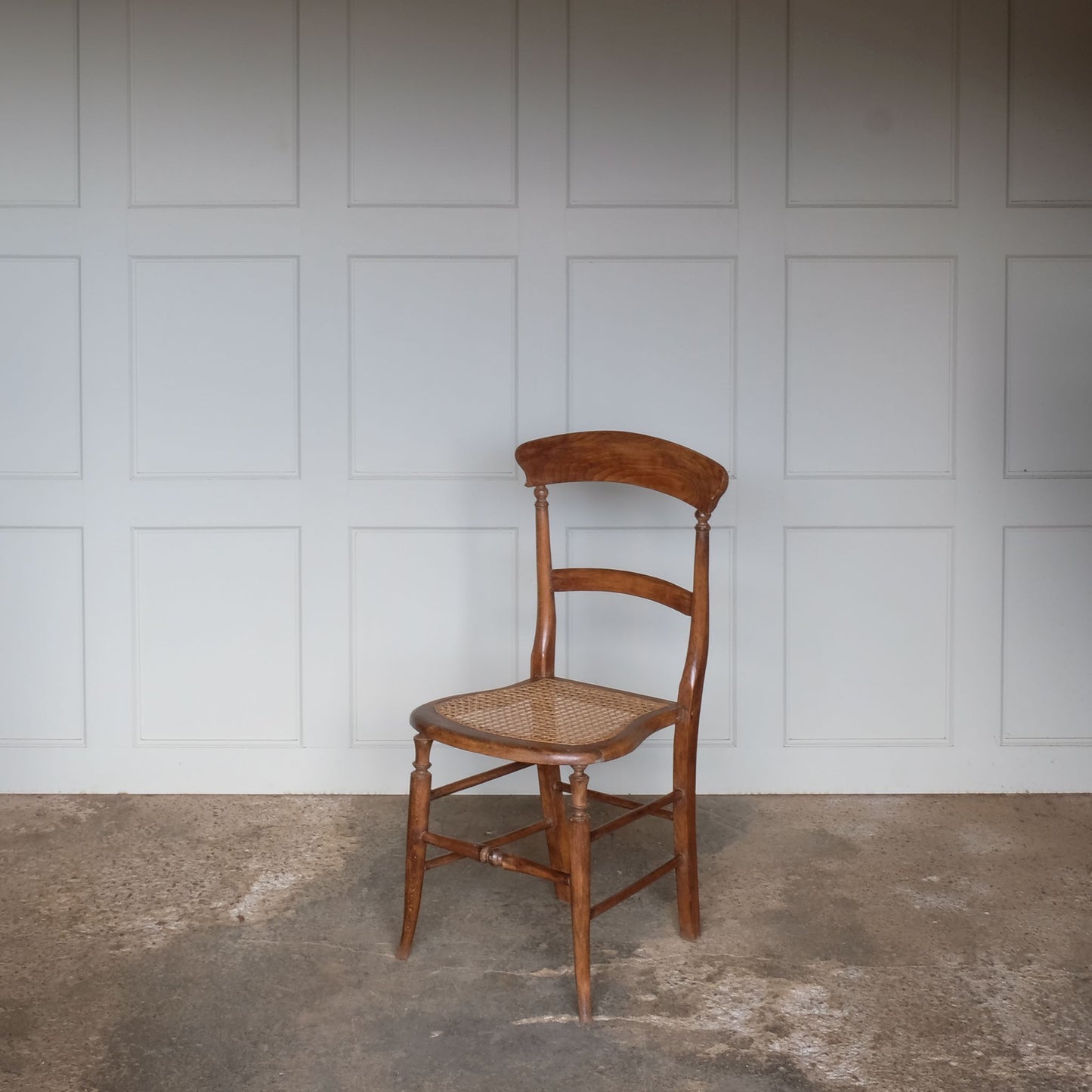 An Edwardian cane seated elm chair, a particularly elegant and charming design. A lovely gentle patina throughout, in very good, sturdy condition.
