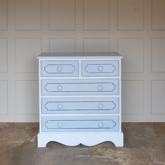 A hand painted blue pine chest of drawers, consisting of two short and three long drawers. The drawers have been painted with an elegant line detail on the front and a vibrant green to the inside and sides. The drawers are painted in a blue a shade deeper than the main body of the chest. In good sturdy condition, with all drawers running smoothly.