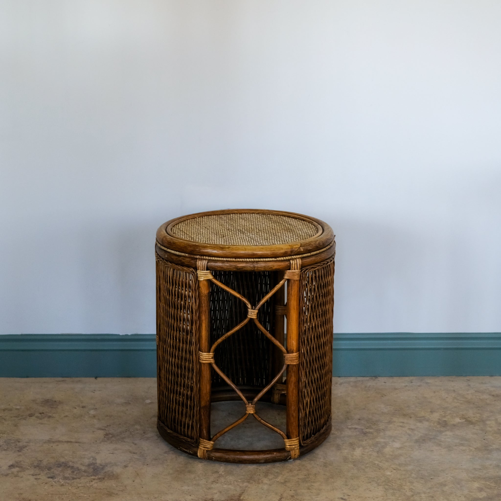 Wicker side table against a plain wall
