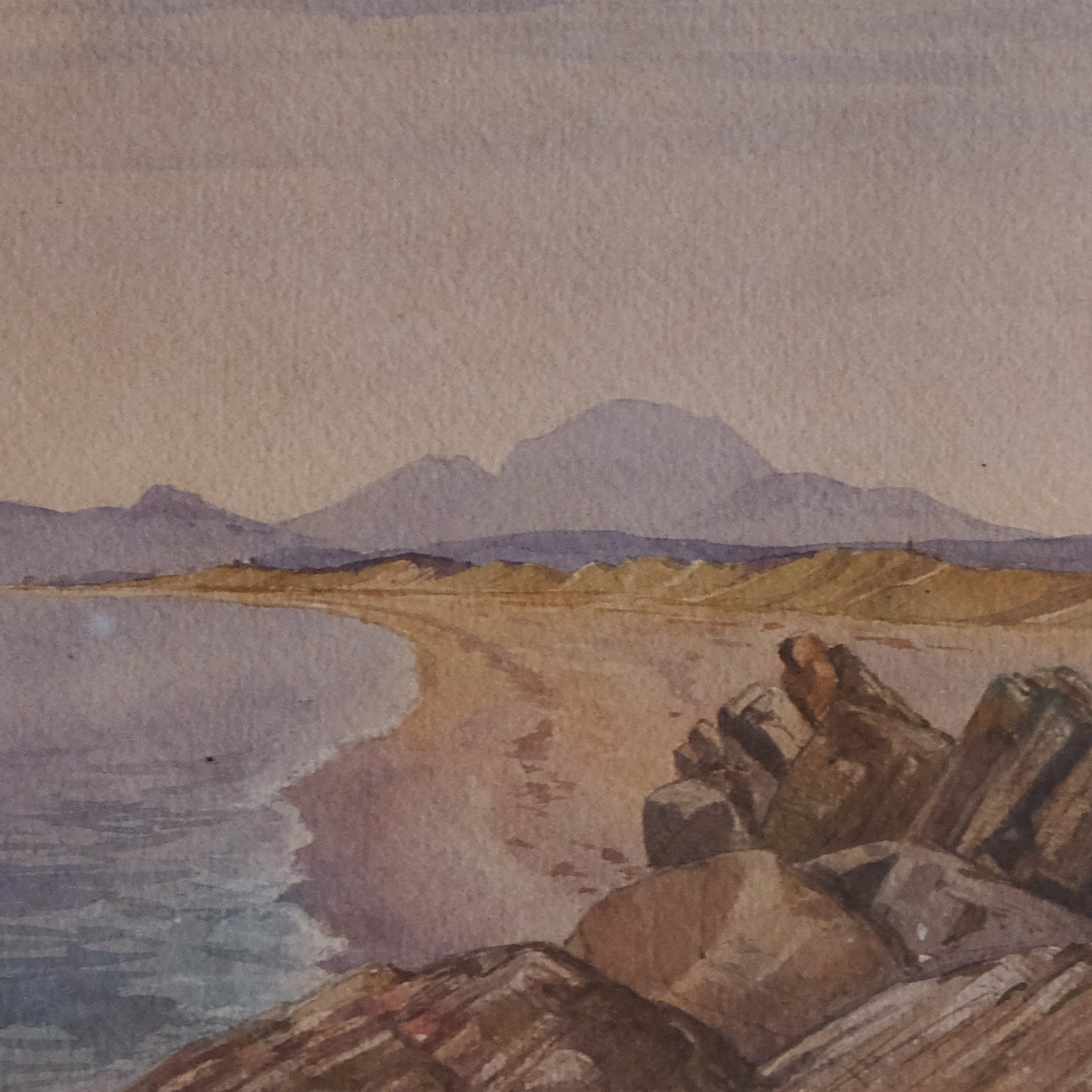 COASTAL LANDSCAPE WITH MOUNTAINS IN THE DISTANCE