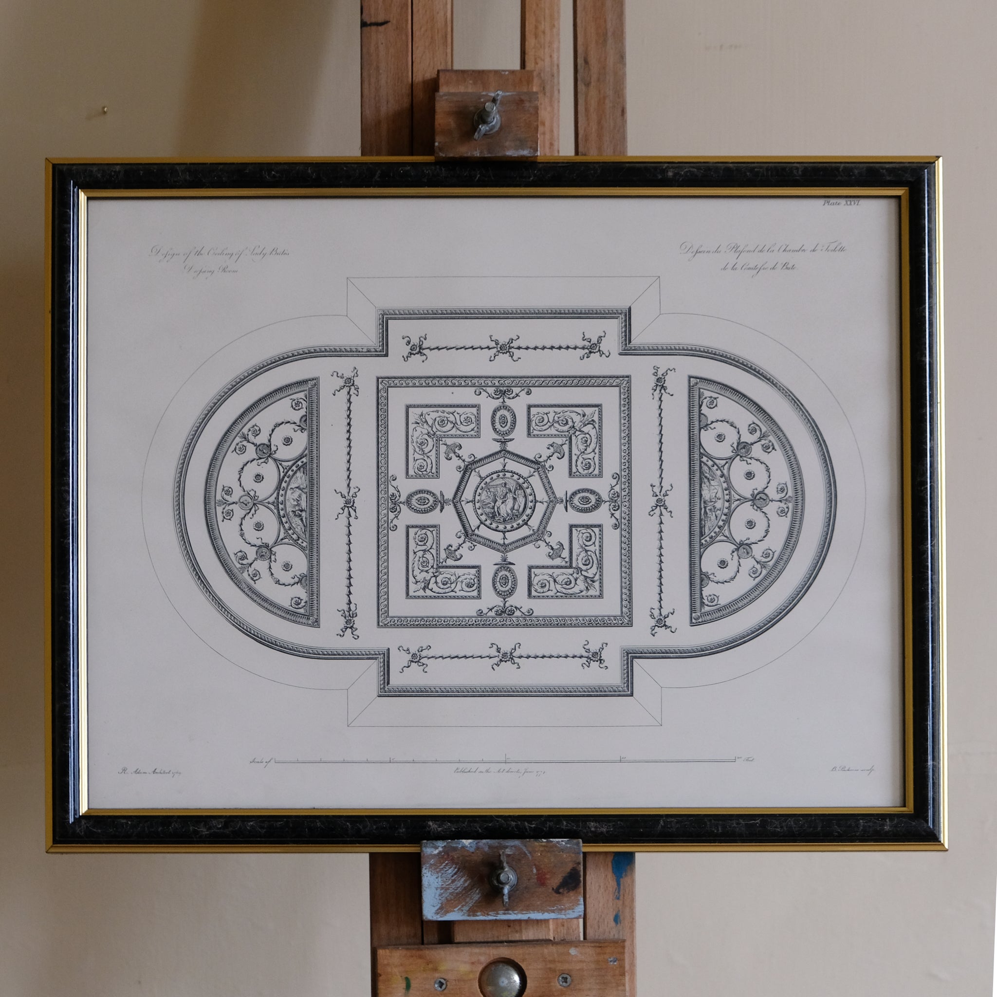 Framed architectural drawing on an easel against a plain wall. Robert Adam
