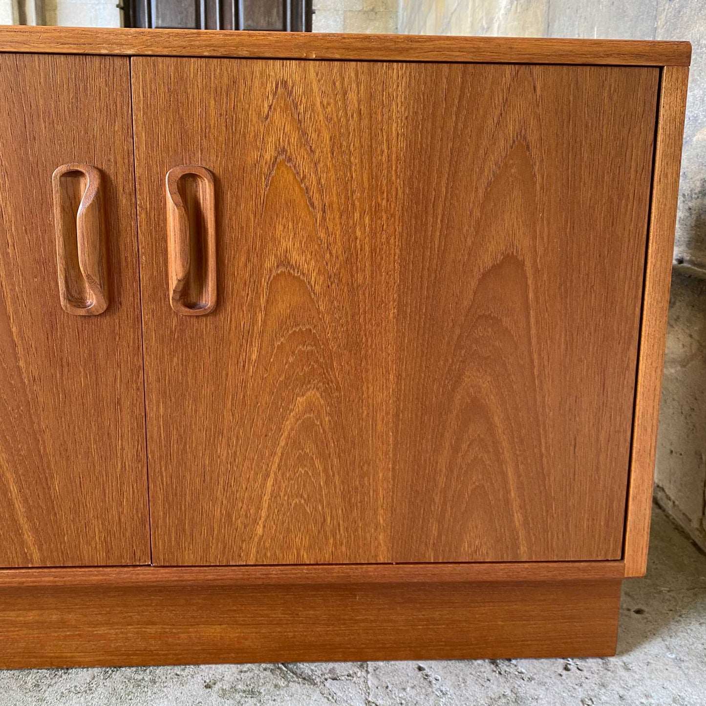 A low teak mid century sideboard by G Plan. Two spacious cabinets, each with a pair of doors and single internal shelf. The maker's mark is present inside one of the doors. In lovely condition, with some very light marks to the top, commensurate with the item's age.
