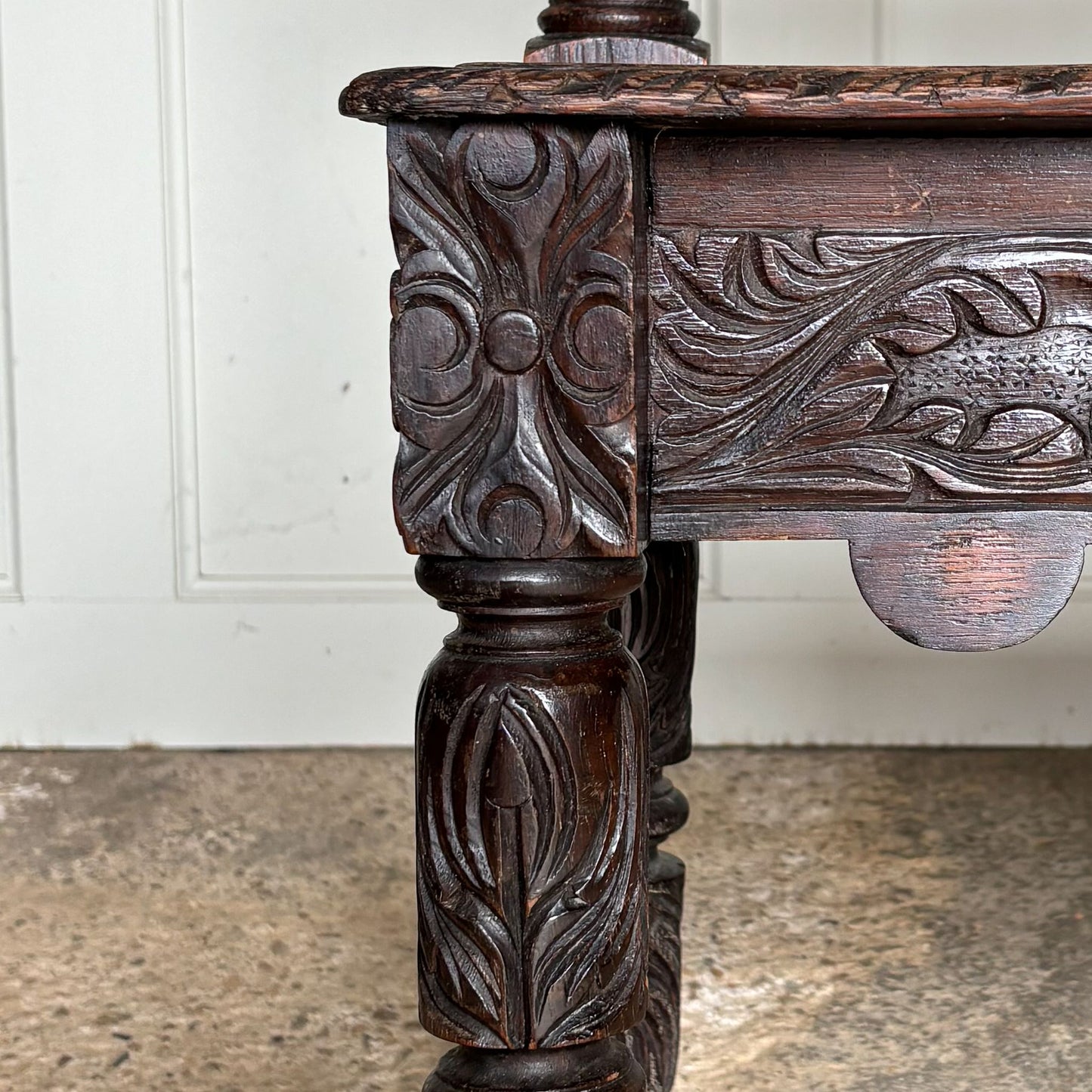 A small oak carved bench, perfect for children, late 19th / early 20th century. With a beautiful foliate carved design. A repaired split to the back rest, in sturdy condition but showing signs of a long and well loved life.