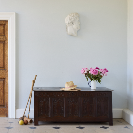 A large 17th century oak coffer with a beautiful five panelled front with stiff leaf carved arcade under a floral top, the moulded rectangular top with the original blacksmith ring hinges. In very good, sturdy condition with a rich patina. Sensitively restored by Anthony Beech, with reclaimed period boards in the base and the top recoloured and waxed. It would be a beautiful storage solution for blankets, toys or a croquet set.