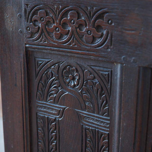 A large 17th century oak coffer with a beautiful five panelled front with stiff leaf carved arcade under a floral top, the moulded rectangular top with the original blacksmith ring hinges. In very good, sturdy condition with a rich patina. Sensitively restored by Anthony Beech, with reclaimed period boards in the base and the top recoloured and waxed. It would be a beautiful storage solution for blankets, toys or a croquet set.