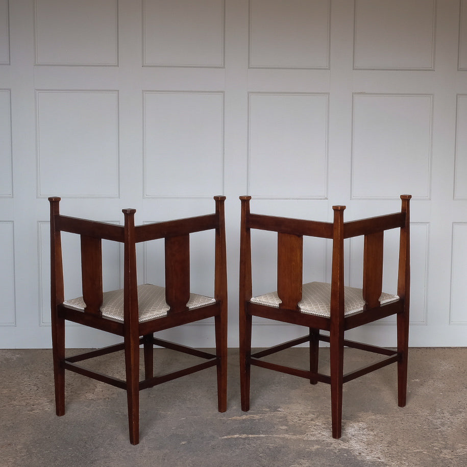 A pair of Arts and Crafts inlaid mahogany corner chairs (rear view), with recently upholstered seat pads - by Summerfield & Scott