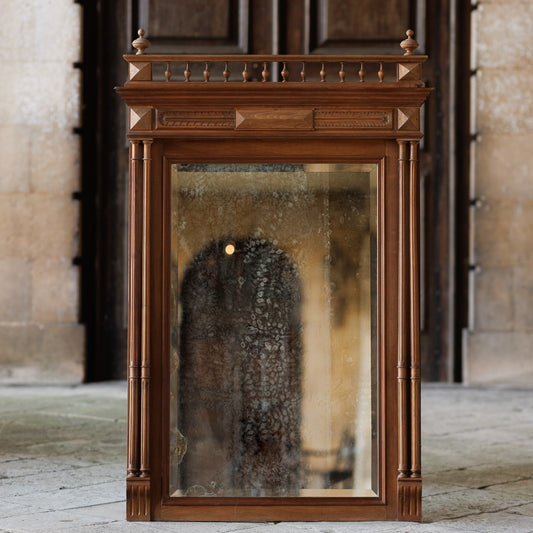 A 19th century pier mirror with original mercury plate in very good condition, some foxing giving a pleasing patina. Flanked on either side by two fluted columns, with detailed carving above.