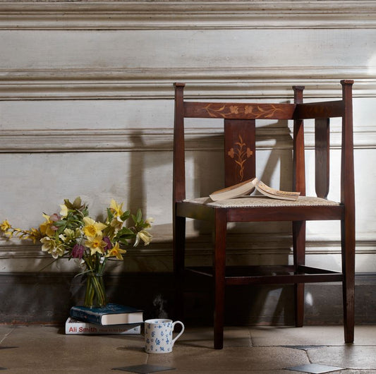 A pair of Arts and Crafts inlaid mahogany corner chairs, with floral design inlay to the backs and recently upholstered seat bases, in very good condition.